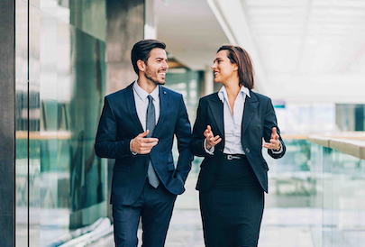 two business people walking and talking together